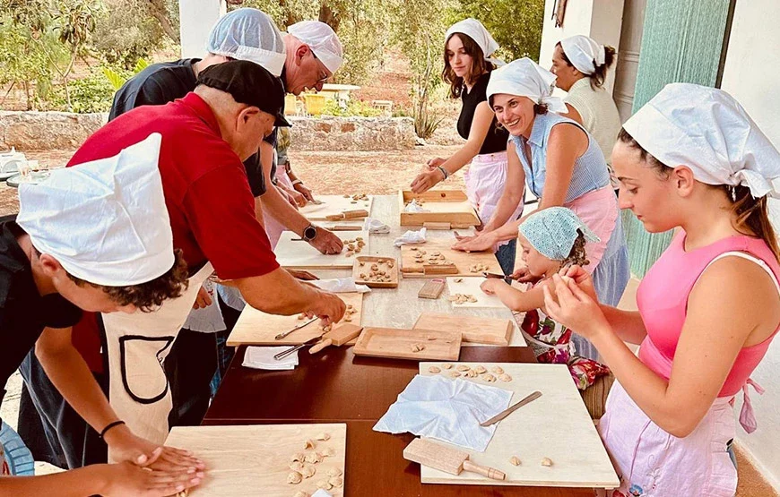 persone che collaborano a un'attività artigianale alla creazione della pasta fresca